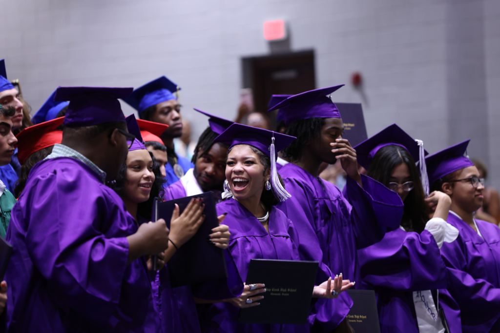 Graduates laughing.