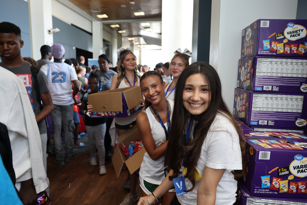 Students smiling by snack area