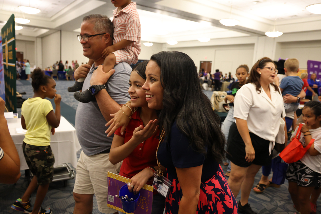 Family smiling walking through convention center