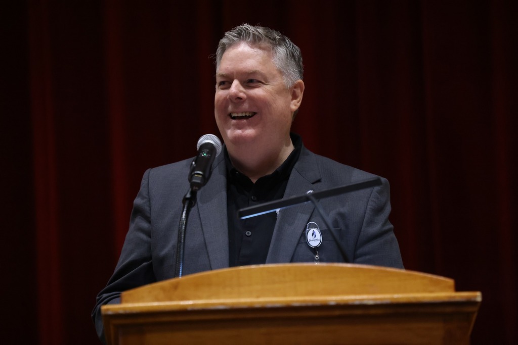superindendent smiling at podium