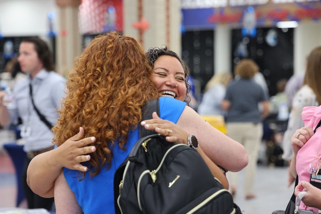 two women hugging and smiling