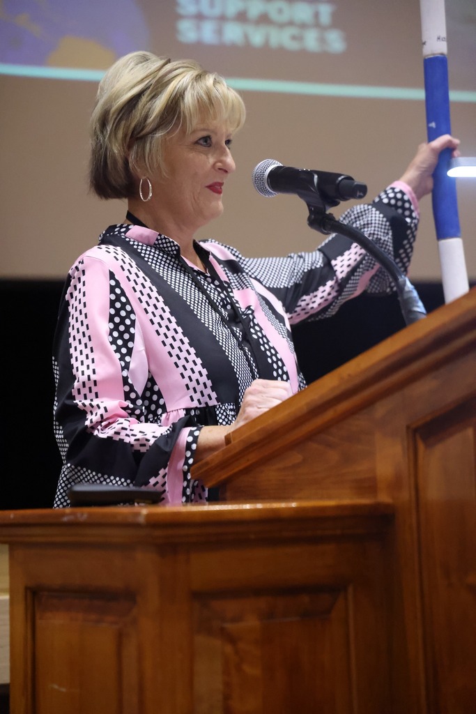 female leader holding spirit stick