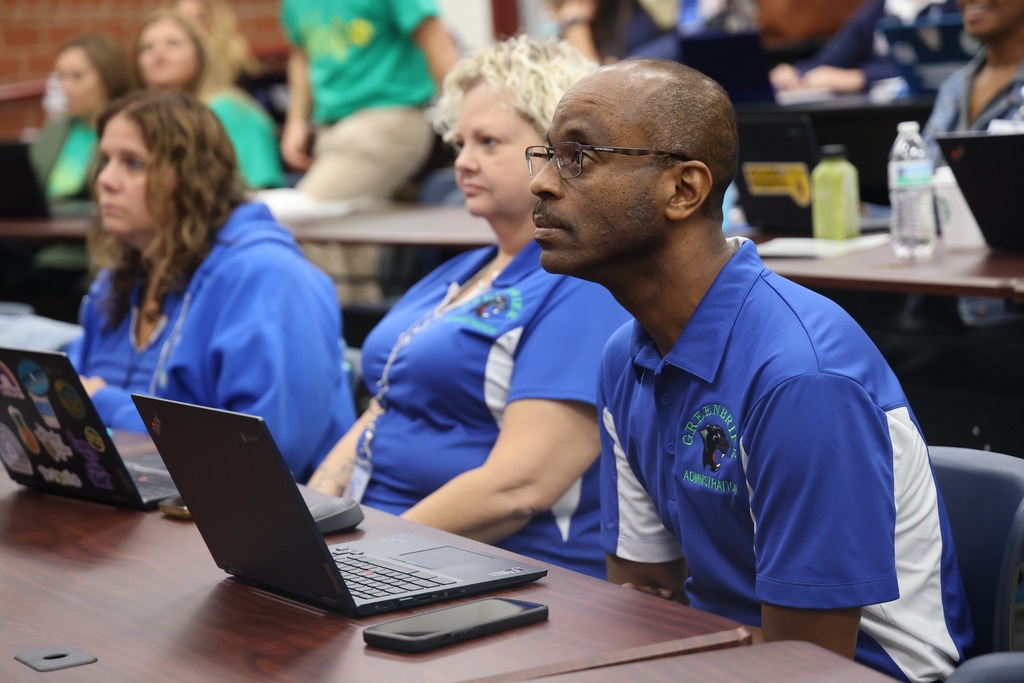male admin focusing in class
