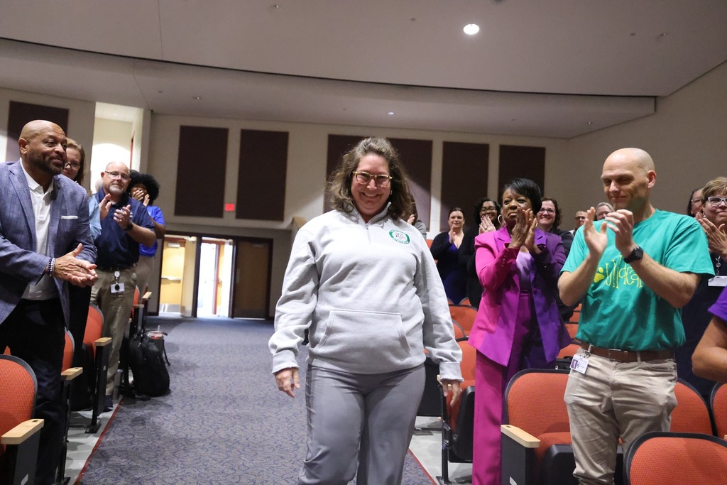female admin walking to receive award