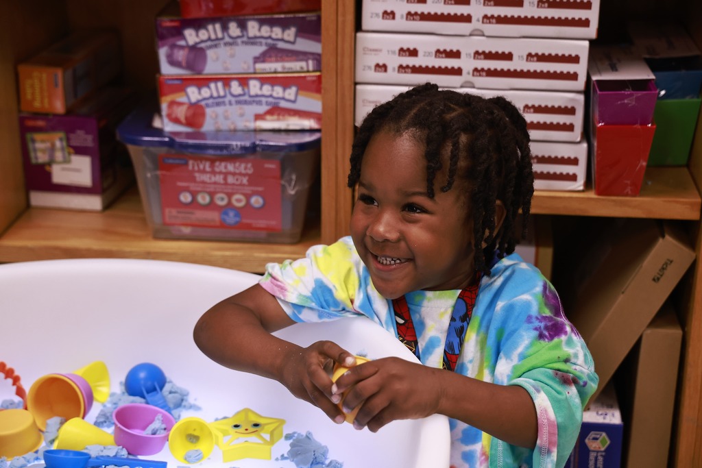 A student plays with toys during the Bridge to Kindergarten summer learning program