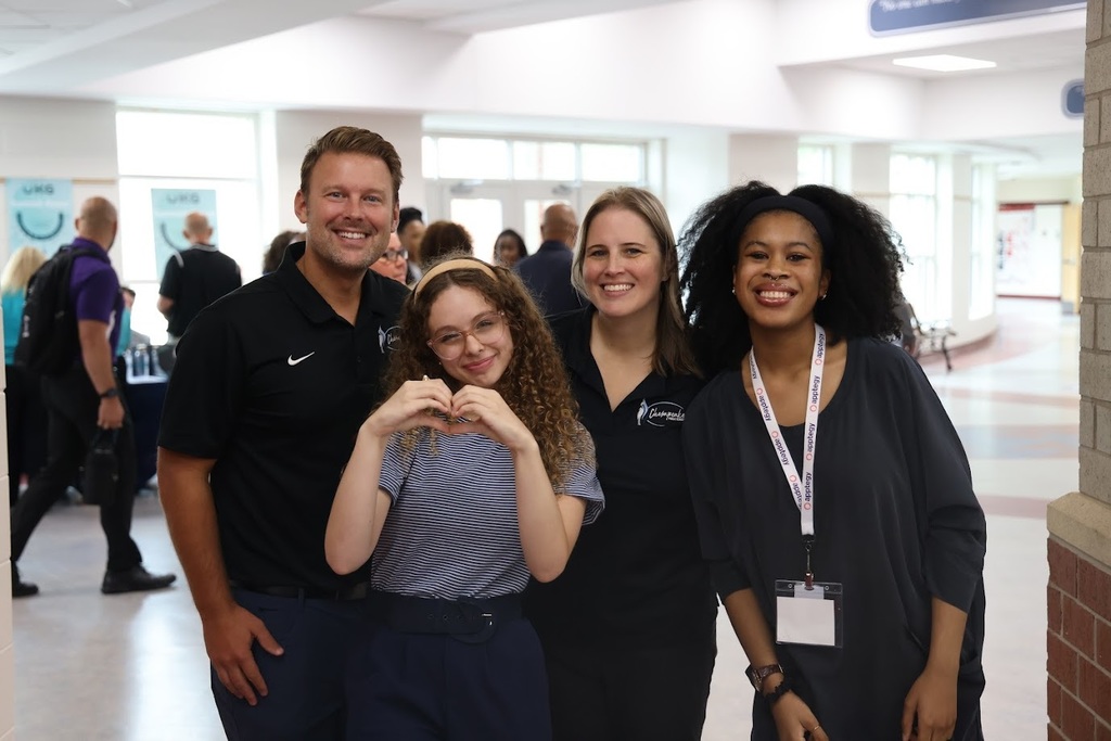 The Communications team with Morgan and Amelia smiling together.
