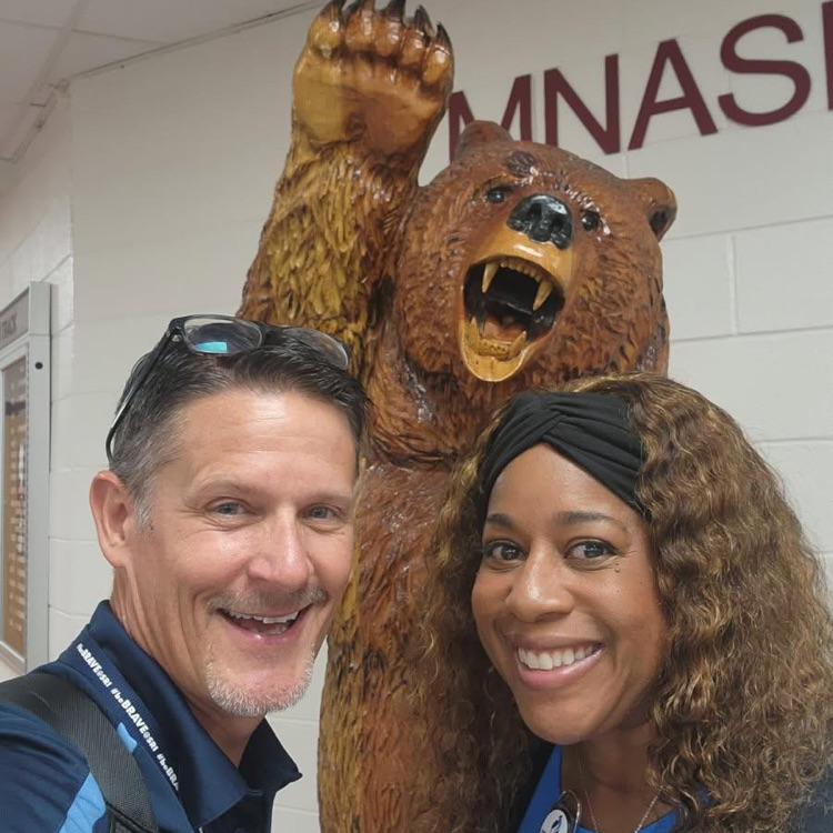 admin with bear statue
