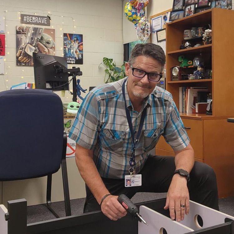 Mr. Triolet building furniture in office