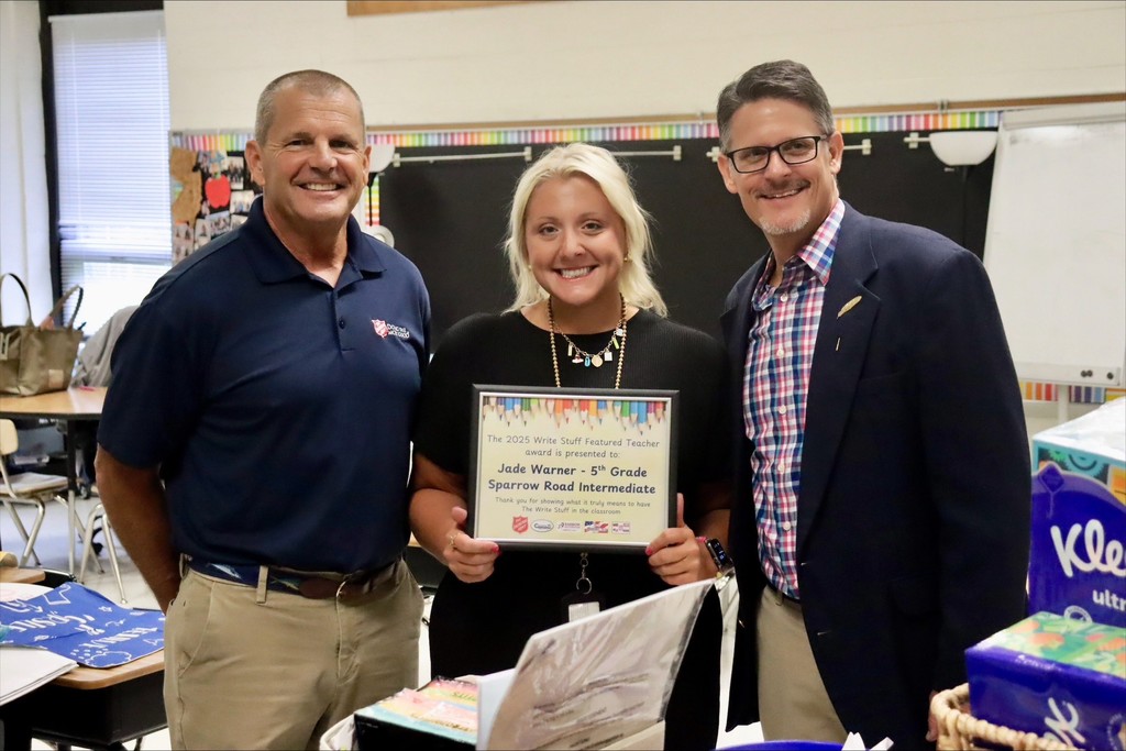 Ms. Warner being presented  with the award and supplies