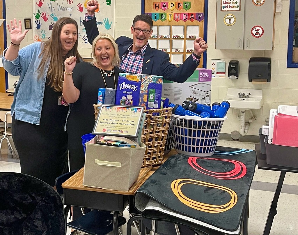 Mrs. Brittingham, Ms. Warner, and Mr. Triolet in Ms. Warner's classroom with the award and supplies