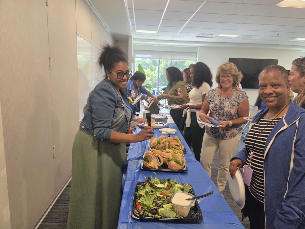 Teacher filling plates of food.