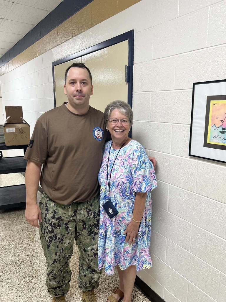 Navy volunteer with teacher.