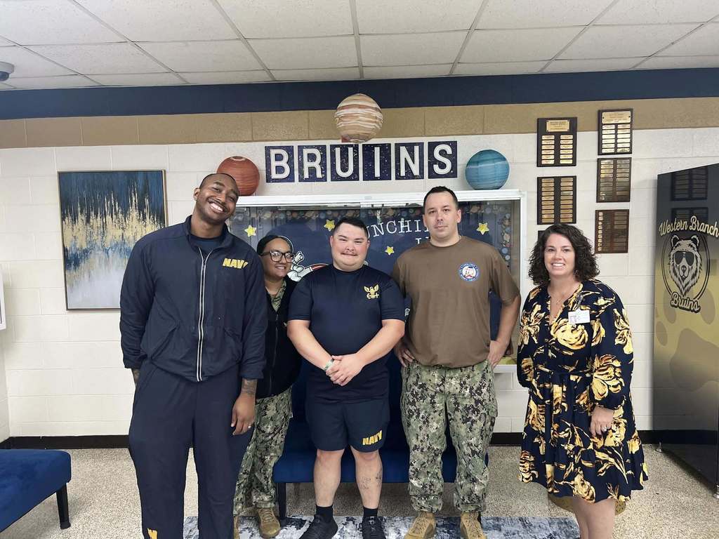 Volunteers smiling at WBP with administration.