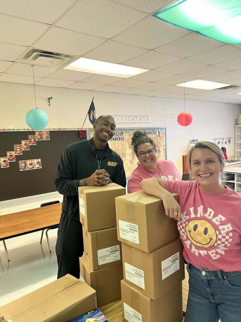 Navy volunteers helping move boxes.