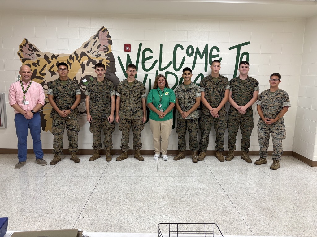 Volunteers smiling together with the GBMS administration.