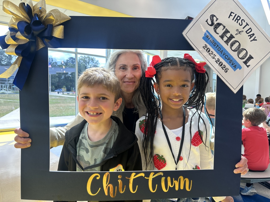 Mrs. Outlaw smiling with two students on the first day of school holding a Chittum Frame!