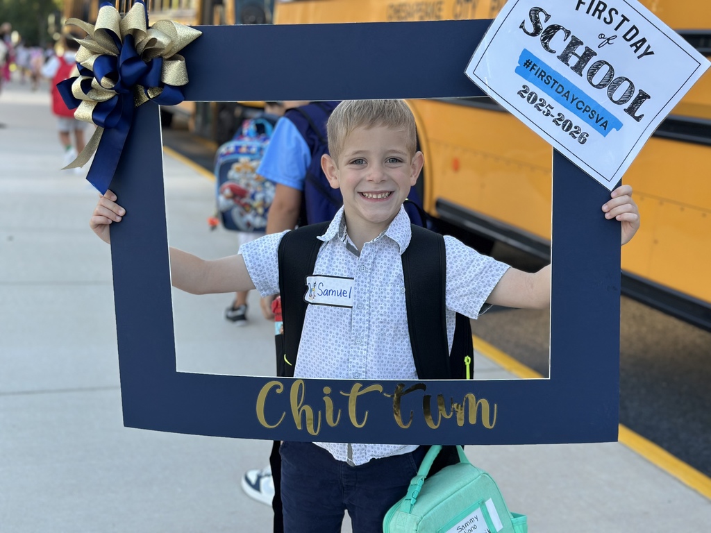 A kindergarten boy excitedly smiling for his first day of school!