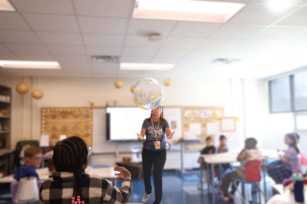 teacher tossing globe
