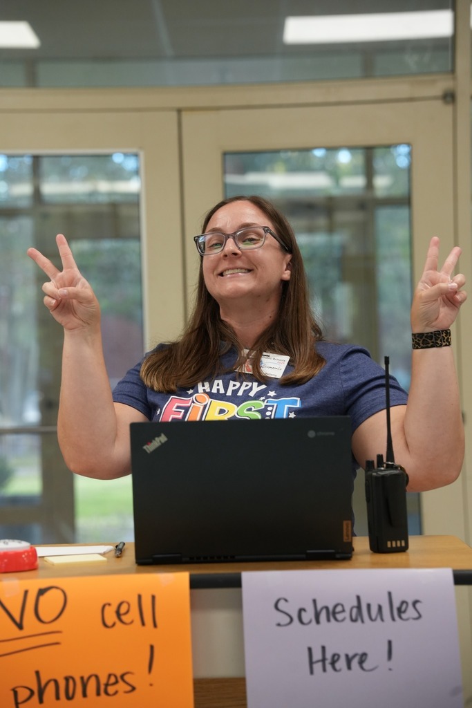 teacher giving peace signs