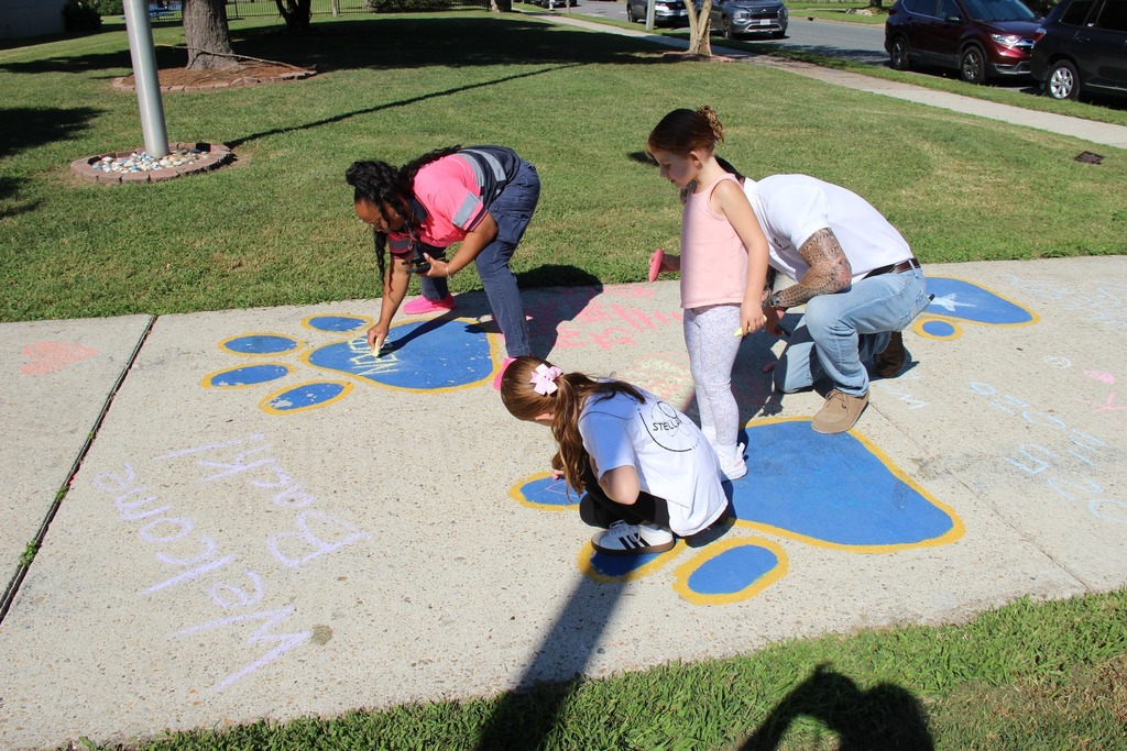People writing with chalk on the sidewalk