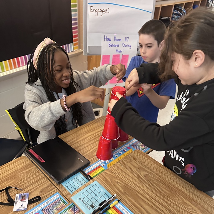 Group of 3 beginning to stack cups together 