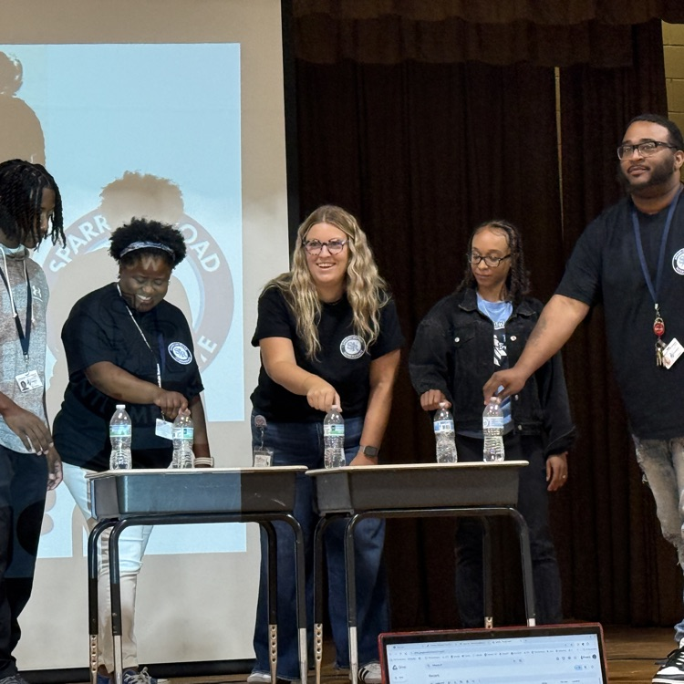 staff with water bottles for the flip bottle challenge 