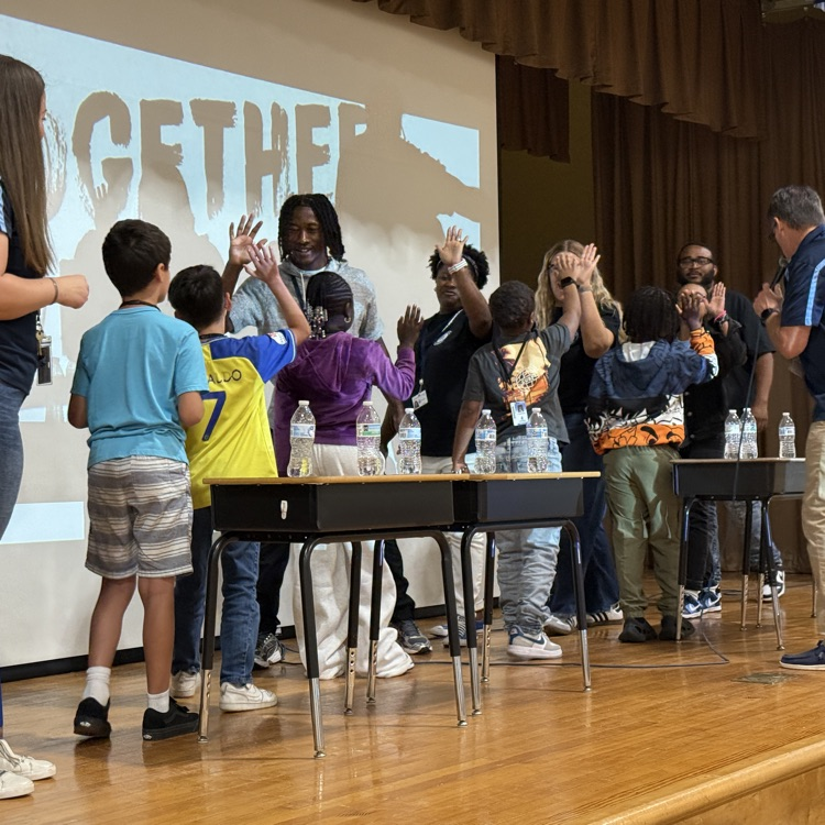 staff and students high fiving 
