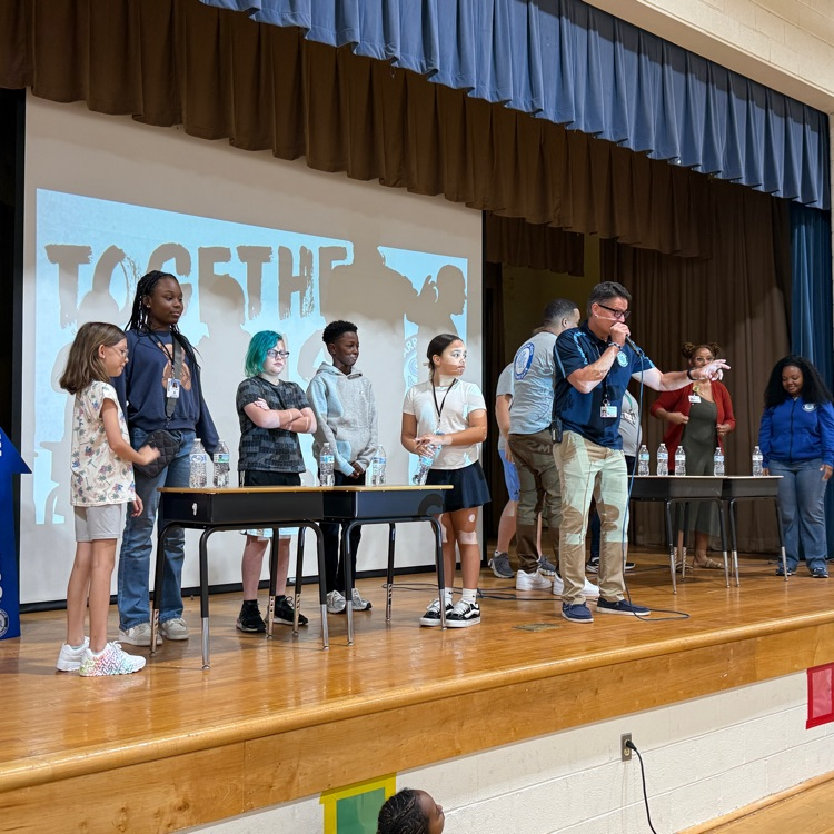 5th graders and staff competing for the bottle flip challenge 