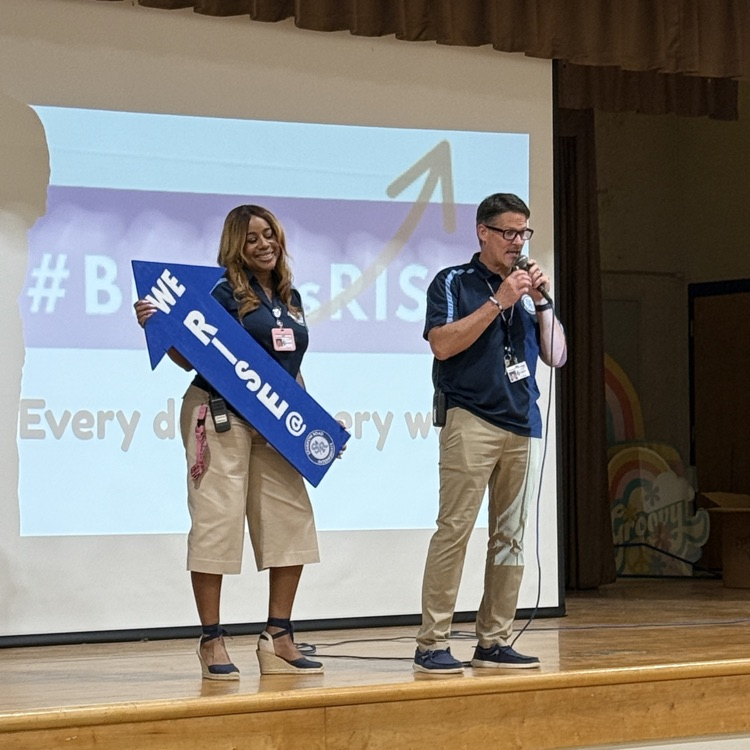 admin with We RISE arrow sign 