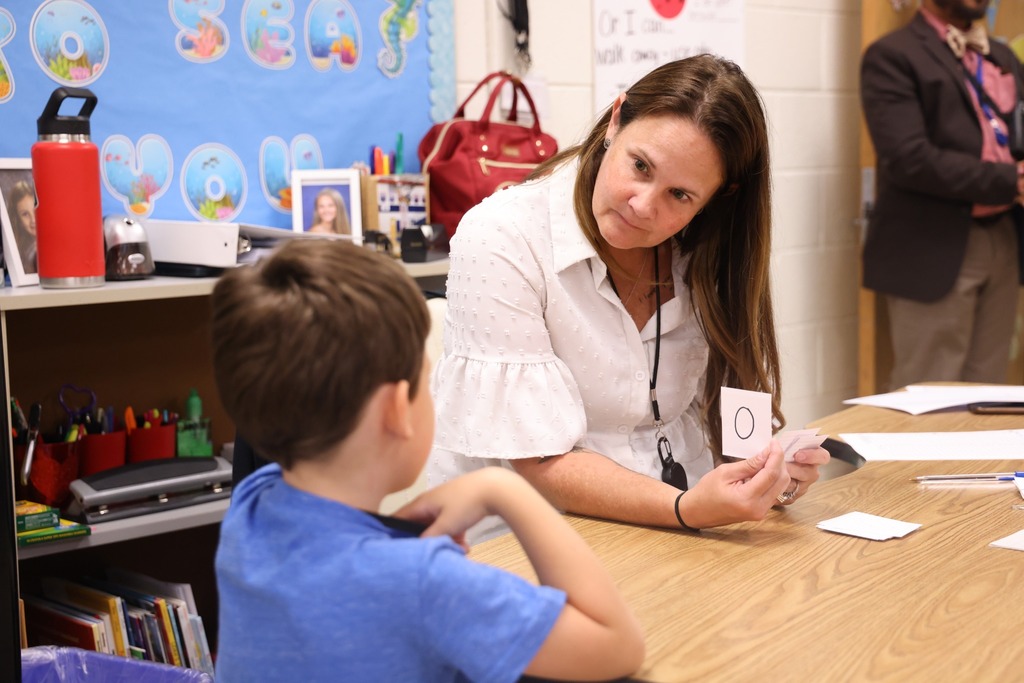 teacher at table with student