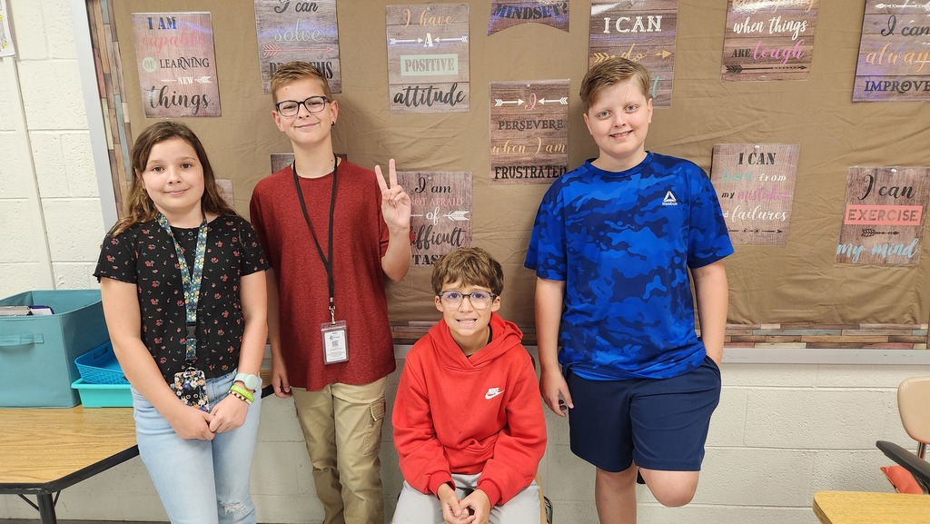 Four students wearing red, white, and blue