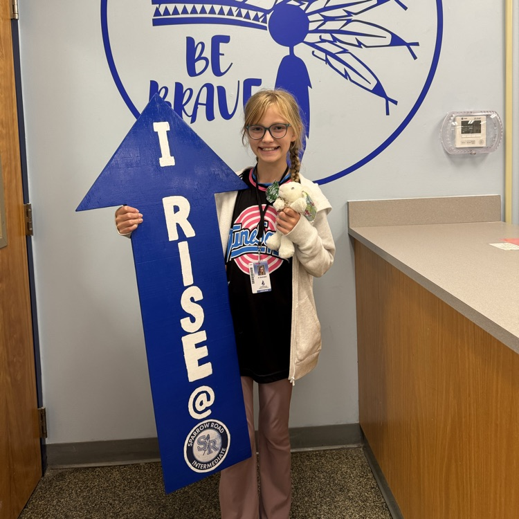 Arabella with I RISE sign