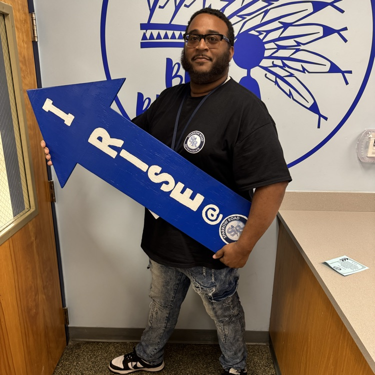 Mr. Golden with I RISE sign