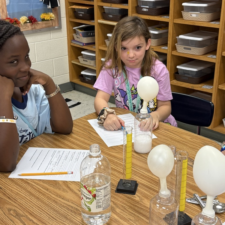 students watching balloon fill up with gas 