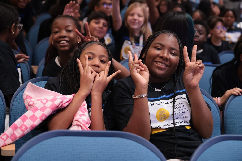 two girls giving peace signs