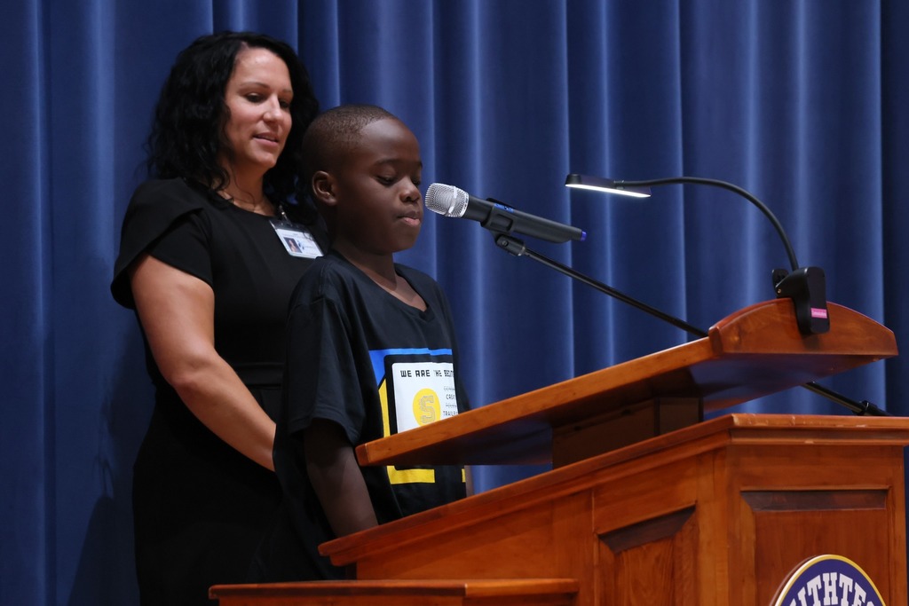 teacher and student at speaker podium