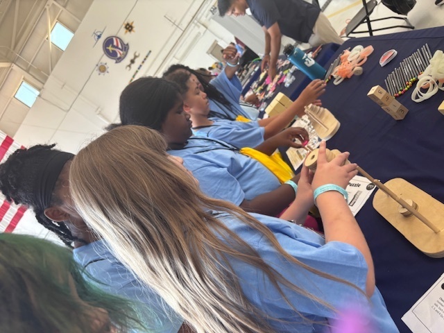 Students at table with wooden activities