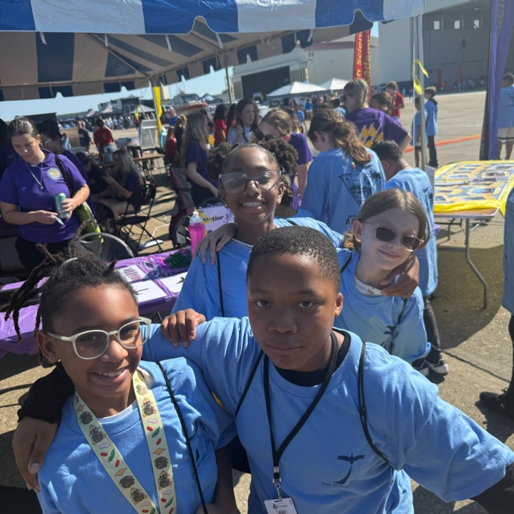 students in front of stem booths