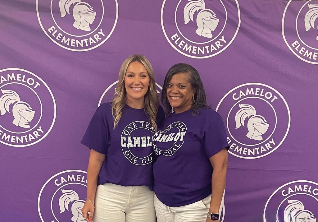 assistant principal and principal standing together