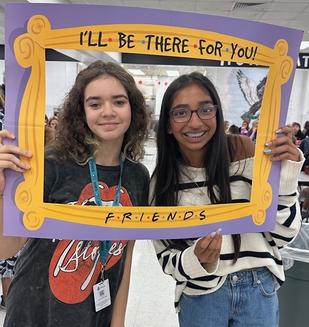students in a frame that says "I'll Be There For You" Friends theme