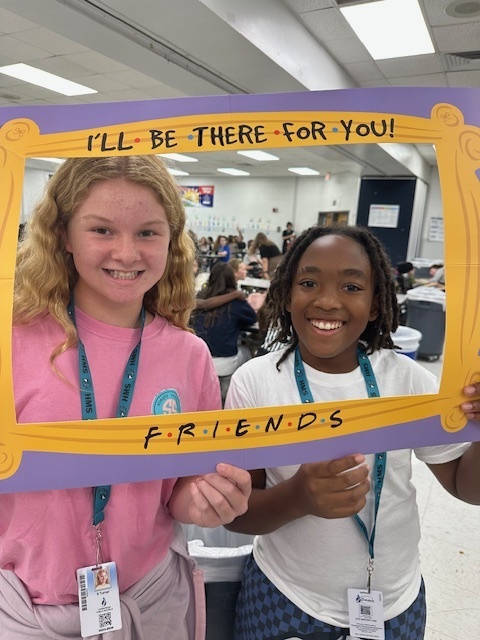 students in a frame that says "I'll Be There For You" Friends theme