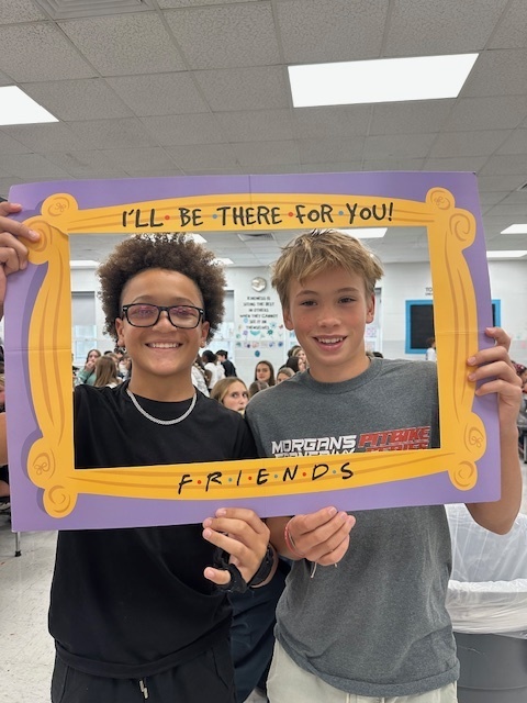 students in a frame that says "I'll Be There For You" Friends theme