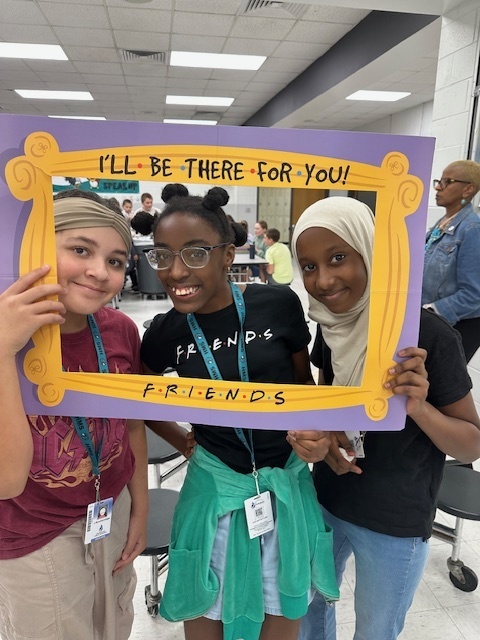 students in a frame that says "I'll Be There For You" Friends theme