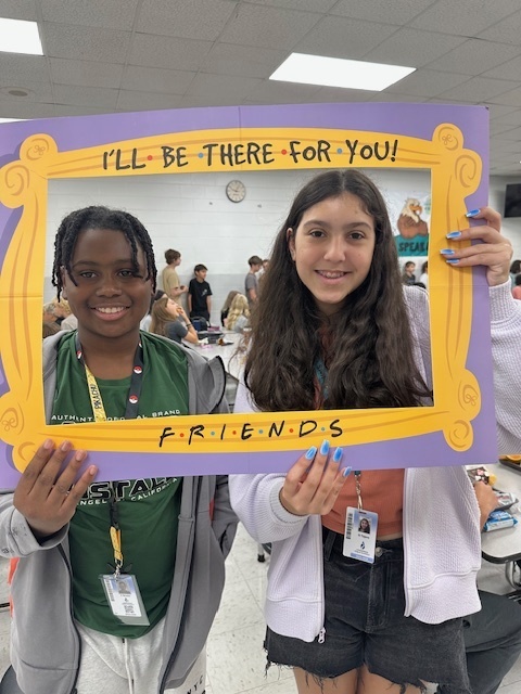 students in a frame that says "I'll Be There For You" Friends theme