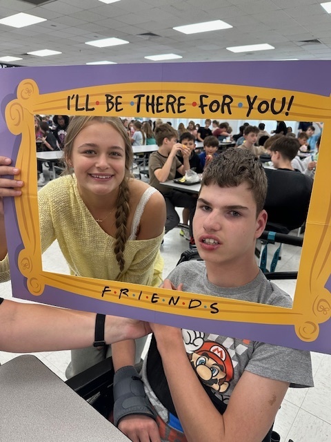 students in a frame that says "I'll Be There For You" Friends theme