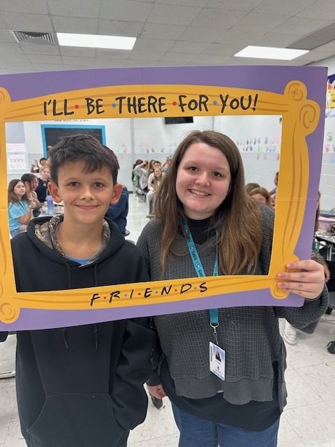 students in a frame that says "I'll Be There For You" Friends theme