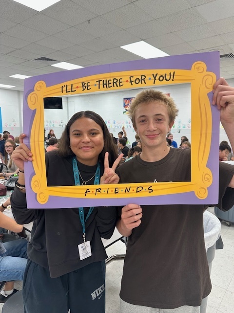 students in a frame that says "I'll Be There For You" Friends theme