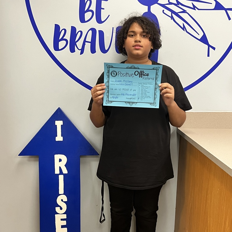 student holding Positive Office Referral