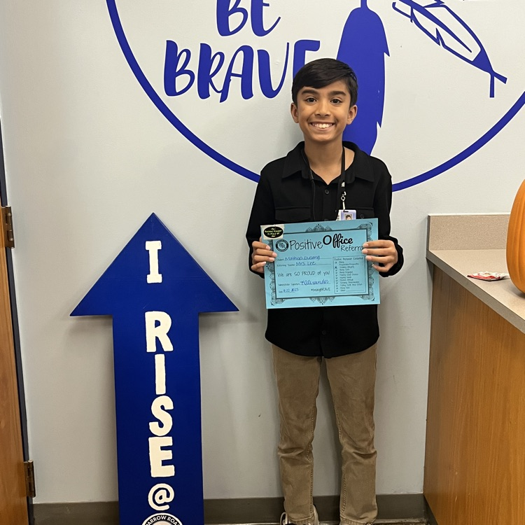 student holding Positive Office Referral