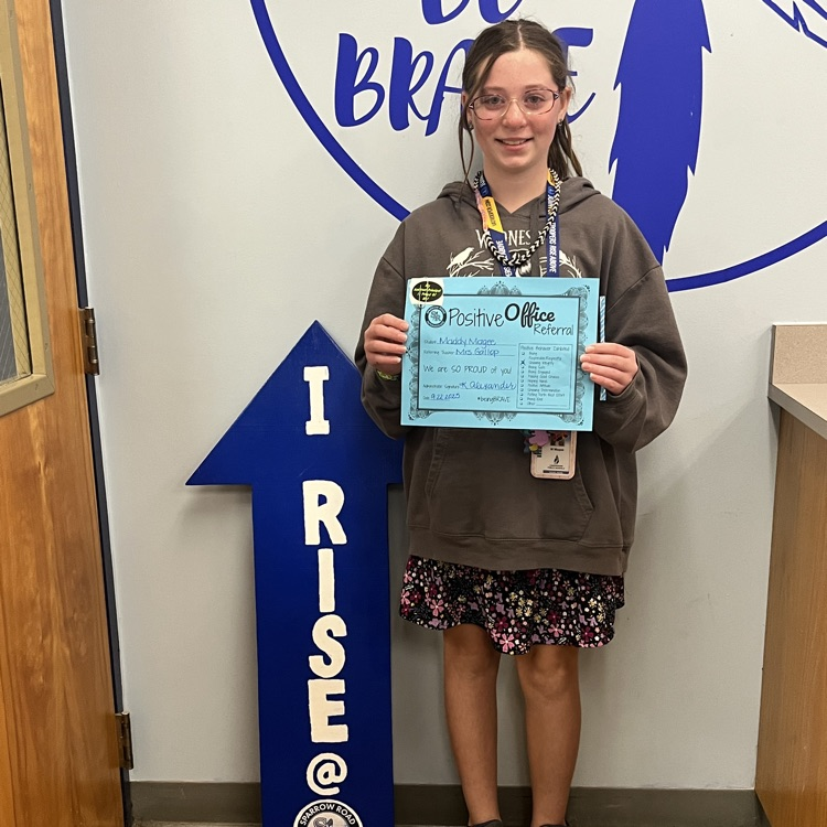 student holding Positive Office Referral